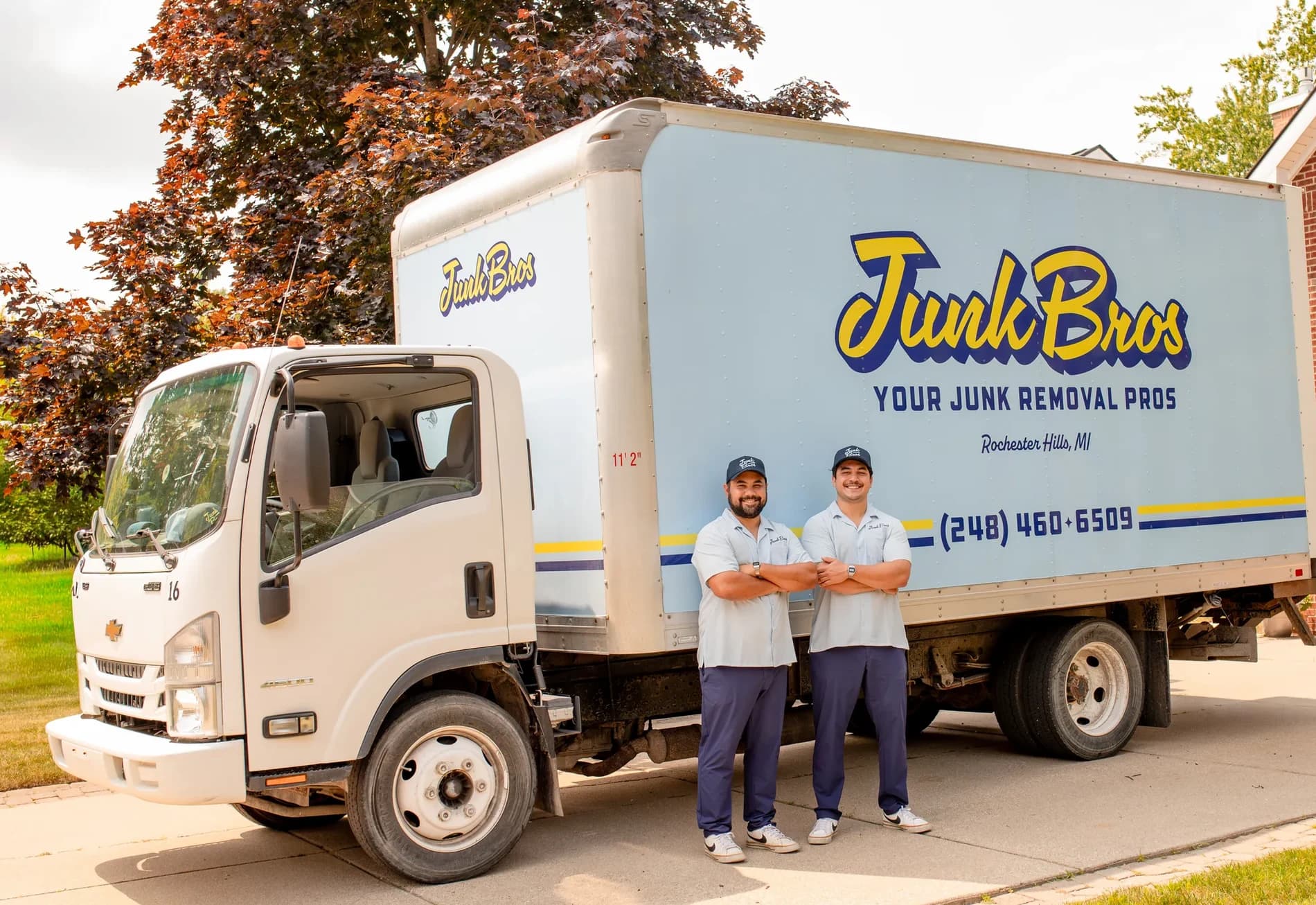 Matt and Brad standing in front of the Junk Bros truck